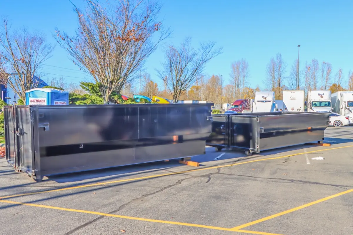 Professional dumpster rental service with roll-off container on residential driveway in Carson City